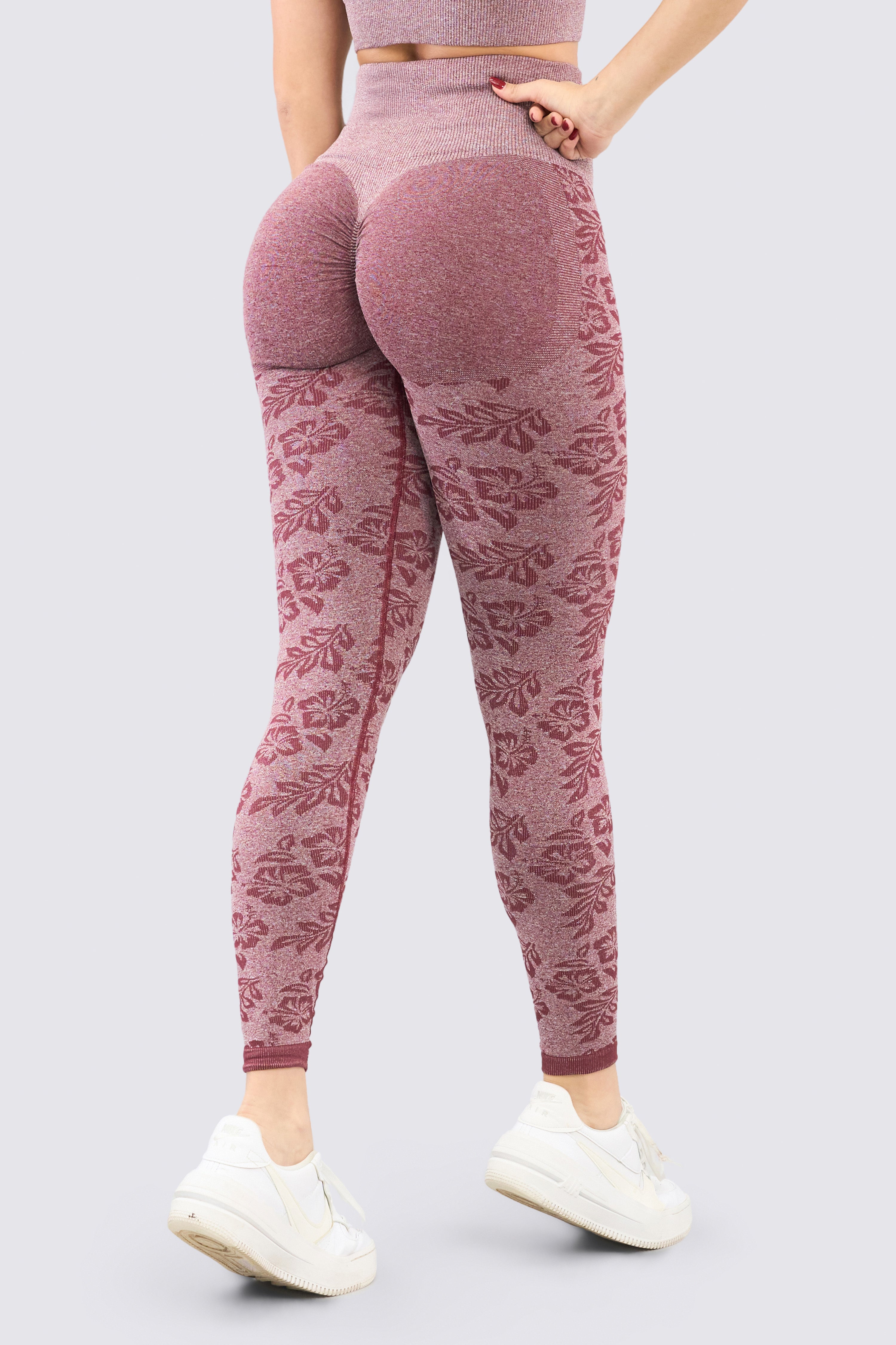 Seamless burgundy sports leggings with floral pattern, high waistband, and compression. 